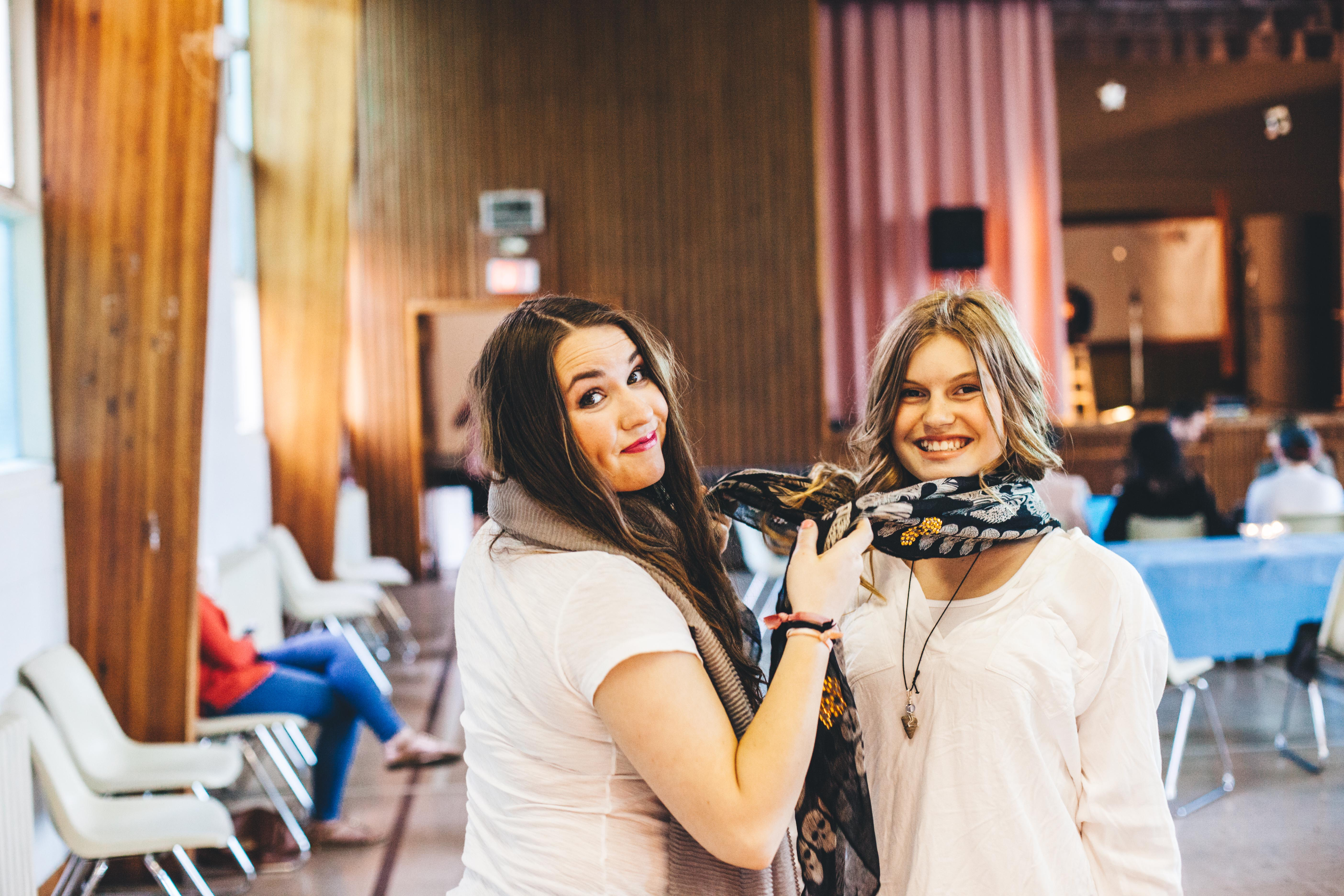 Two friends sharing a laugh right before the talent show