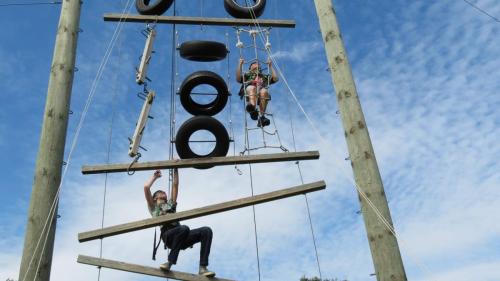 Student climbing tower structure