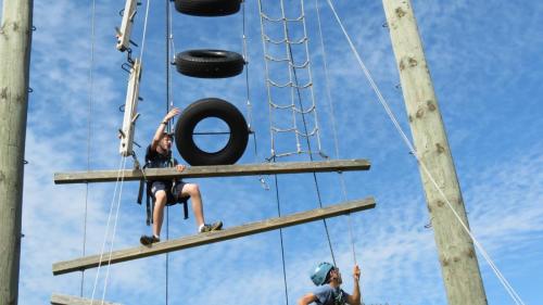 Student climbing tower structure