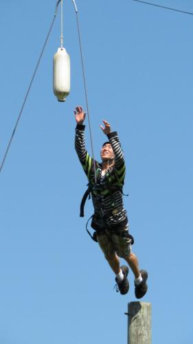 Student reaching during climb