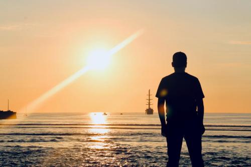 Student on beach at sunset