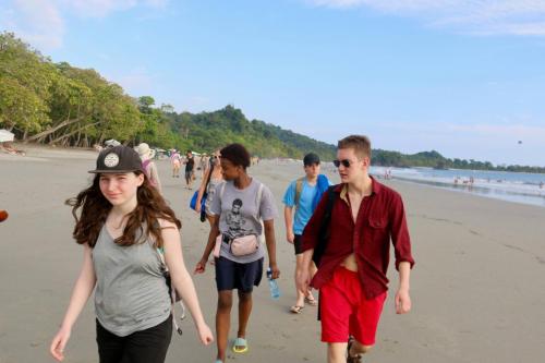 Group of students walking on the beach