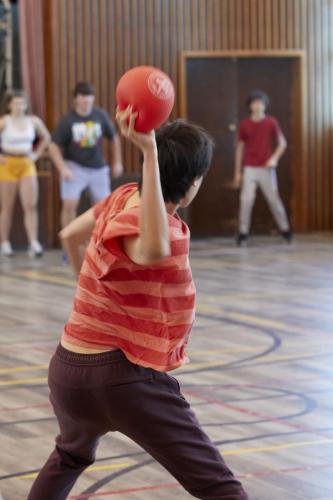 Student throwing ball in game of dodgeball