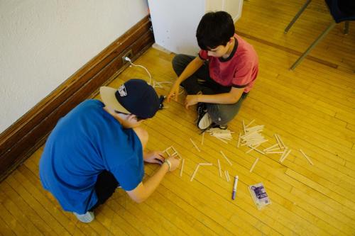 Two students engaged in building activity