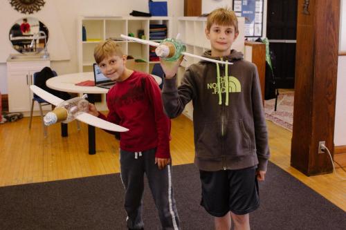 Two students presenting their model planes